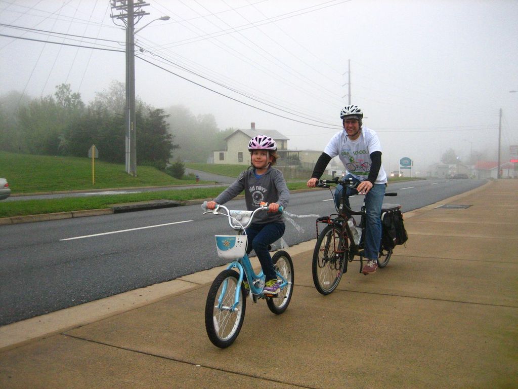 Trent Wagler and his daughter Maya ride to school